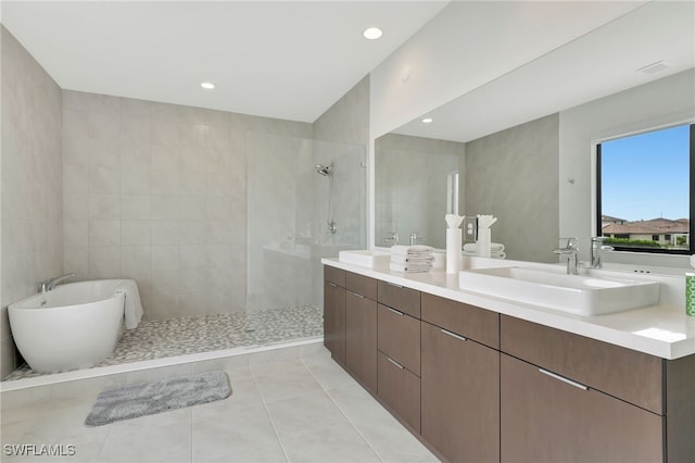 bathroom featuring vanity, tile walls, separate shower and tub, and tile patterned flooring