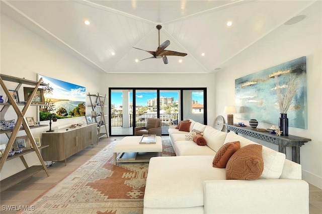 living room featuring high vaulted ceiling and light hardwood / wood-style floors