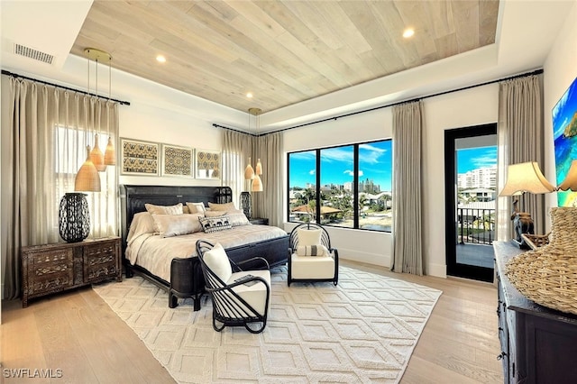 bedroom with a raised ceiling, access to exterior, wood ceiling, and light hardwood / wood-style floors