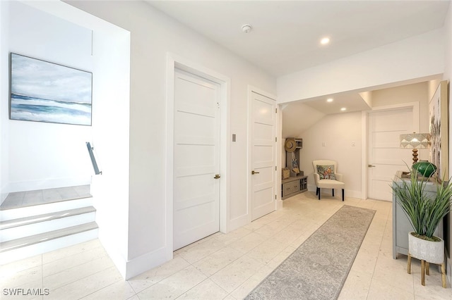 corridor featuring vaulted ceiling