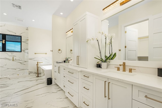 bathroom with vanity and a tub to relax in