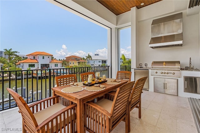 balcony with area for grilling, exterior kitchen, sink, and a patio area