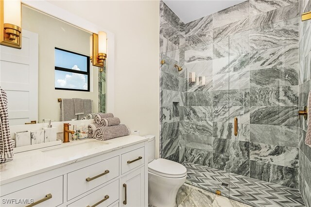 bathroom with walk in shower, vanity, and toilet