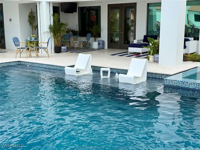 view of pool featuring french doors and a patio area