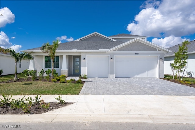 view of front of property with a front yard and a garage