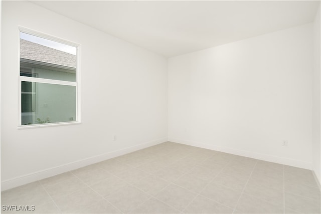 empty room with light tile patterned flooring