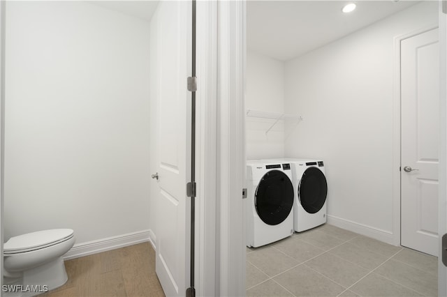 laundry room with washer and dryer and light tile patterned floors