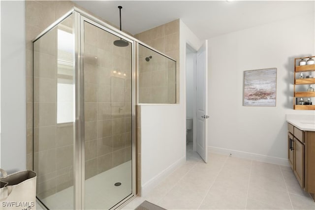 bathroom featuring vanity, toilet, tile patterned floors, and a shower with door