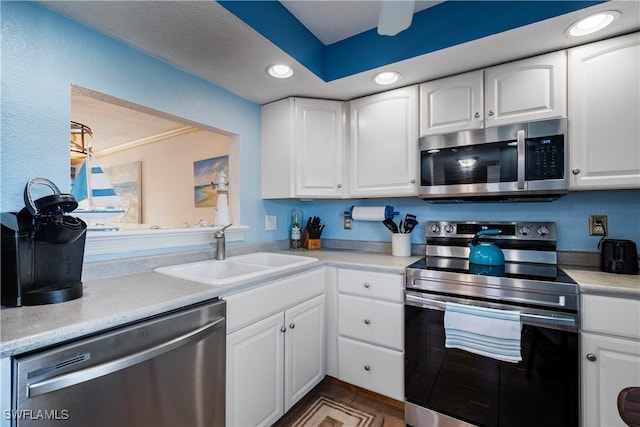 kitchen featuring stainless steel appliances, sink, and white cabinets