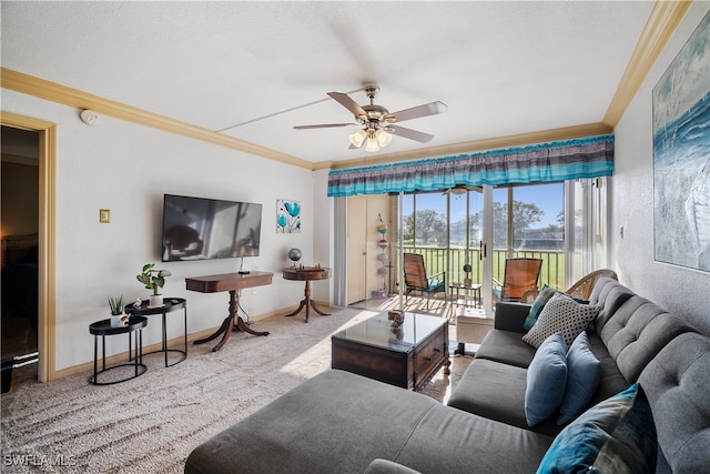 living room featuring ornamental molding, carpet floors, and ceiling fan