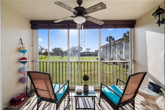 sunroom / solarium featuring plenty of natural light and ceiling fan