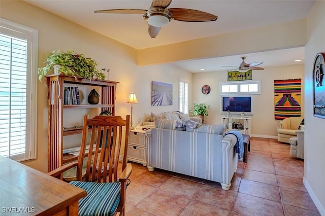 tiled living room featuring ceiling fan