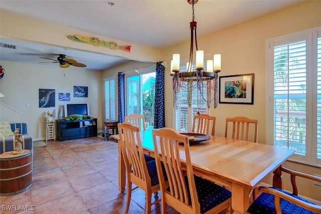 dining area with ceiling fan with notable chandelier