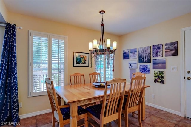 dining area with an inviting chandelier and tile patterned floors