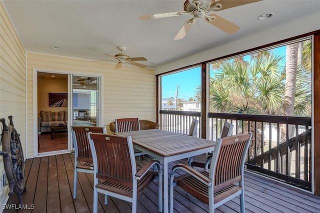 sunroom / solarium featuring ceiling fan