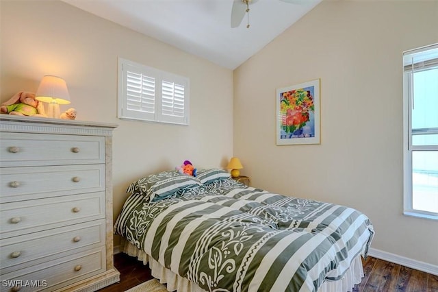 bedroom with dark hardwood / wood-style flooring, vaulted ceiling, and ceiling fan