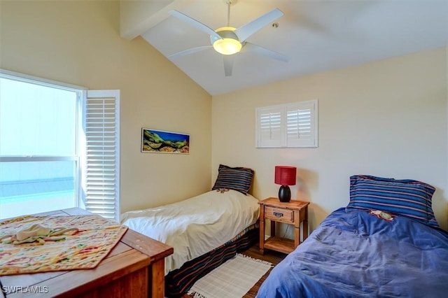 bedroom featuring ceiling fan, lofted ceiling with beams, and multiple windows