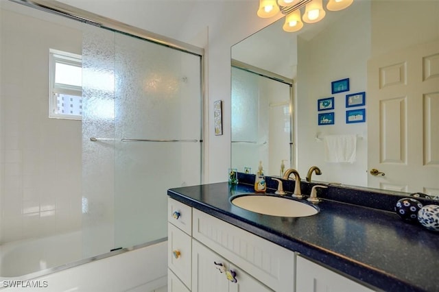 bathroom featuring vanity and shower / bath combination with glass door