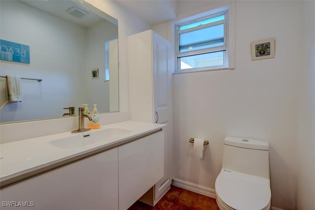 bathroom featuring vanity, tile patterned floors, and toilet