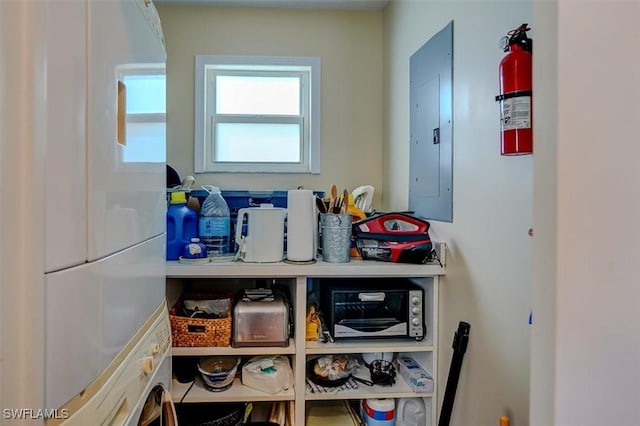 pantry with stacked washer / drying machine and electric panel