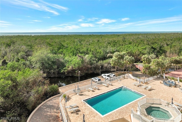 view of swimming pool featuring a water view