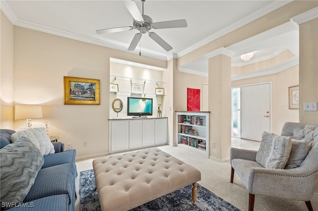 living room with decorative columns, ceiling fan, light colored carpet, and ornamental molding