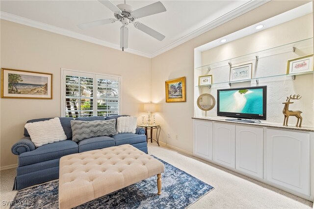 carpeted living room featuring ceiling fan and ornamental molding