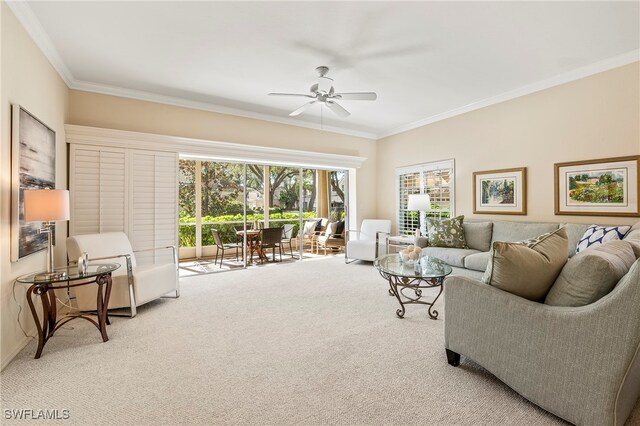 carpeted living room featuring ceiling fan and crown molding