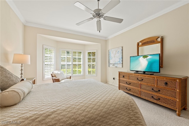 carpeted bedroom featuring ceiling fan and ornamental molding