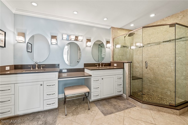 bathroom featuring tile patterned floors, vanity, a shower with shower door, and ornamental molding