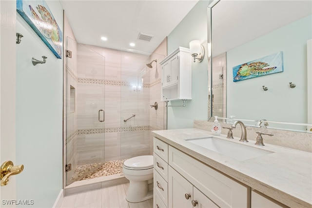 bathroom with vanity, toilet, and walk in shower