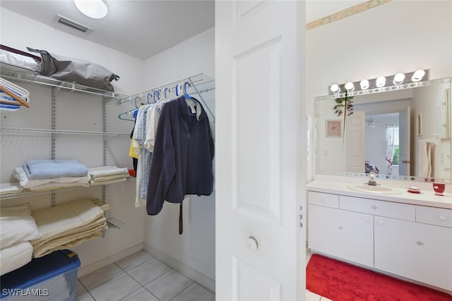 bathroom with tile patterned flooring and vanity