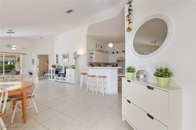 interior space with ceiling fan and a high ceiling