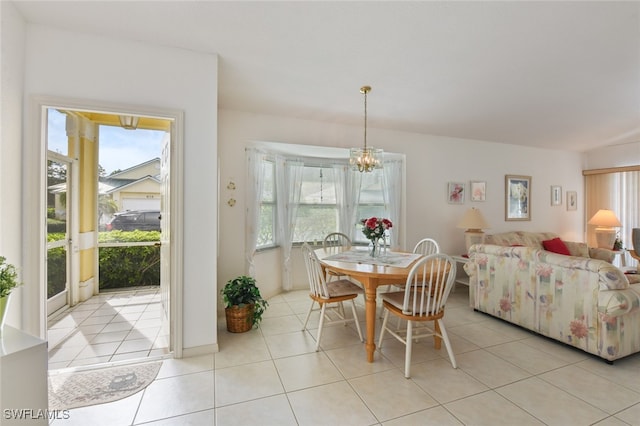 tiled dining room featuring a chandelier