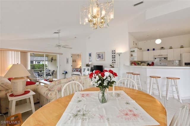 tiled dining room featuring high vaulted ceiling and ceiling fan with notable chandelier