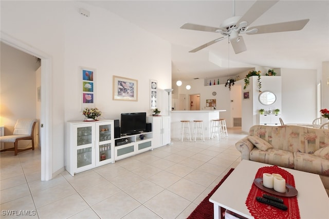 tiled living room featuring high vaulted ceiling and ceiling fan