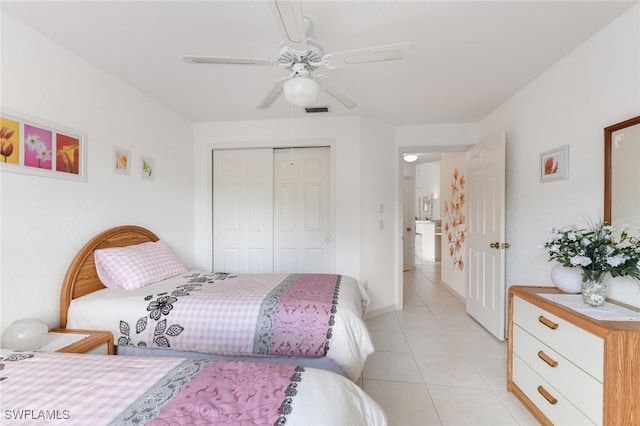 tiled bedroom with a closet and ceiling fan