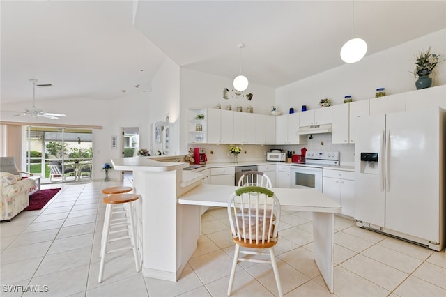 kitchen featuring a kitchen breakfast bar, white appliances, kitchen peninsula, and hanging light fixtures