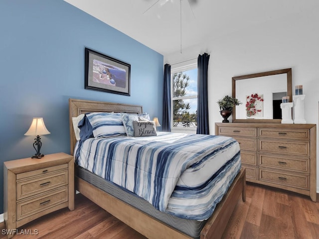 bedroom featuring ceiling fan and dark hardwood / wood-style floors