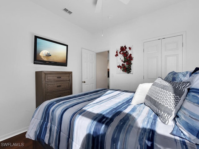 bedroom with ceiling fan, a closet, and dark hardwood / wood-style flooring