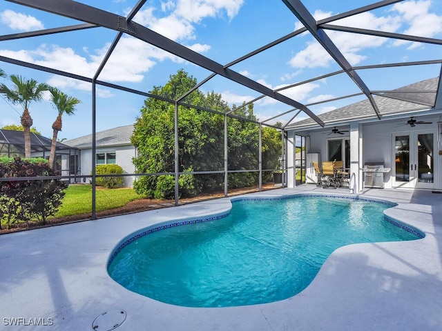 view of pool featuring glass enclosure, french doors, a patio, area for grilling, and ceiling fan