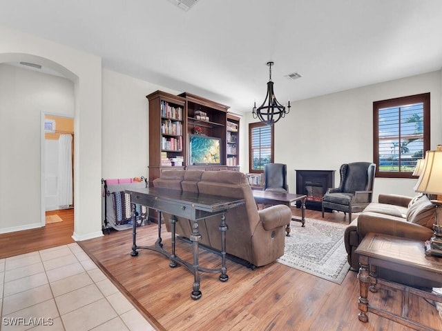 living room featuring light wood-type flooring and a chandelier