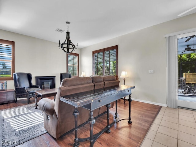 living room with a wealth of natural light and light hardwood / wood-style flooring