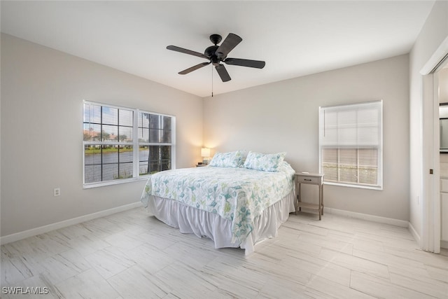 bedroom featuring ceiling fan and multiple windows