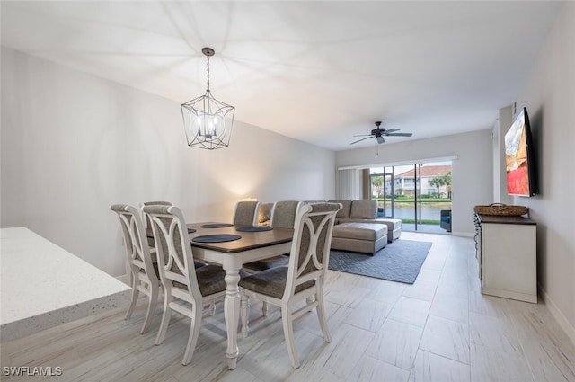 dining room with ceiling fan with notable chandelier