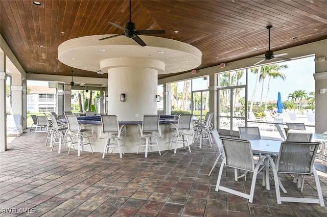 exterior space featuring wood ceiling, a healthy amount of sunlight, and ceiling fan