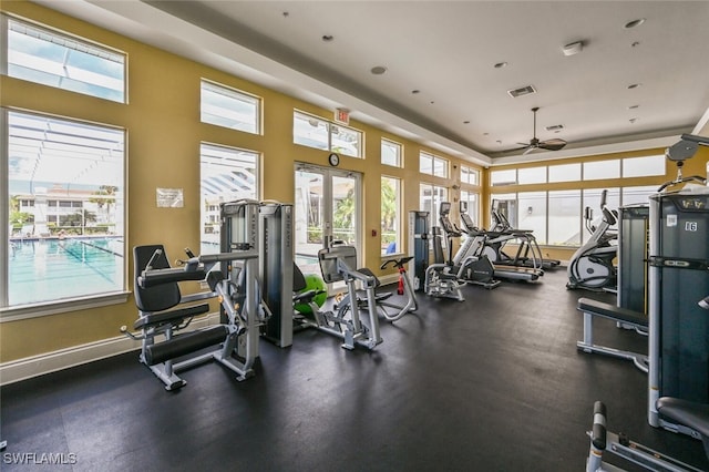 gym featuring a healthy amount of sunlight and ceiling fan