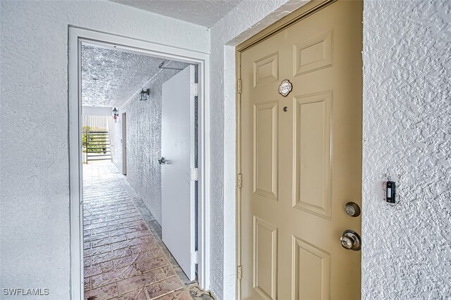 hallway with a textured ceiling