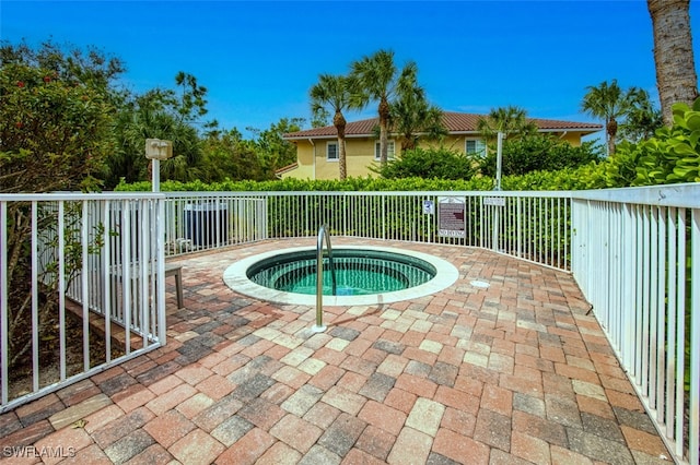 view of pool featuring a hot tub and a patio area