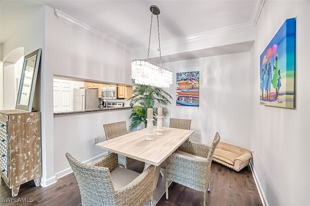 dining area with ornamental molding and dark hardwood / wood-style floors